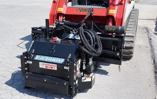 Skid steer with the Blue Diamond heavy duty cold planer attachment in the field