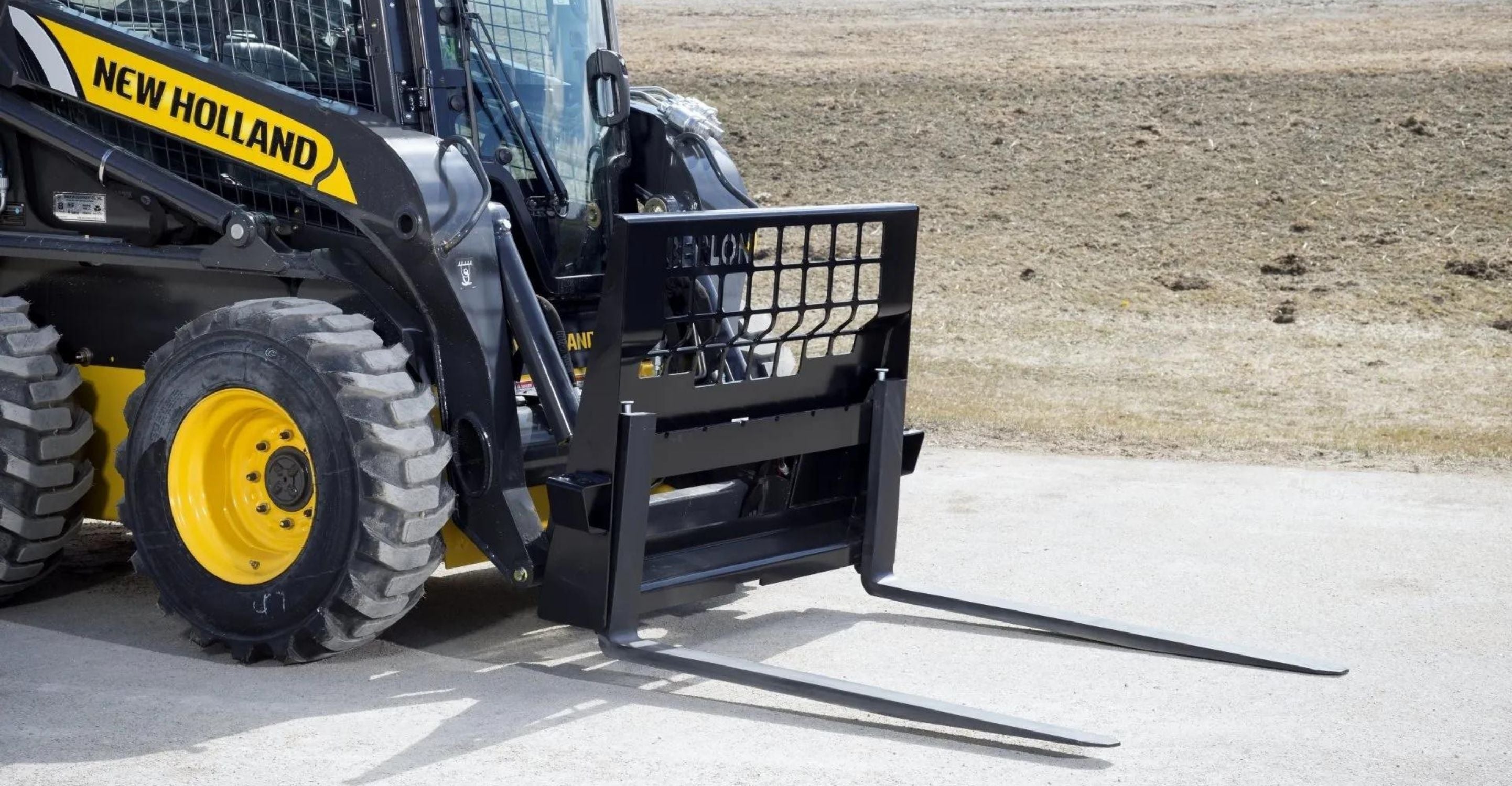 New Holland skid steer with the pallet forks attachment on sale