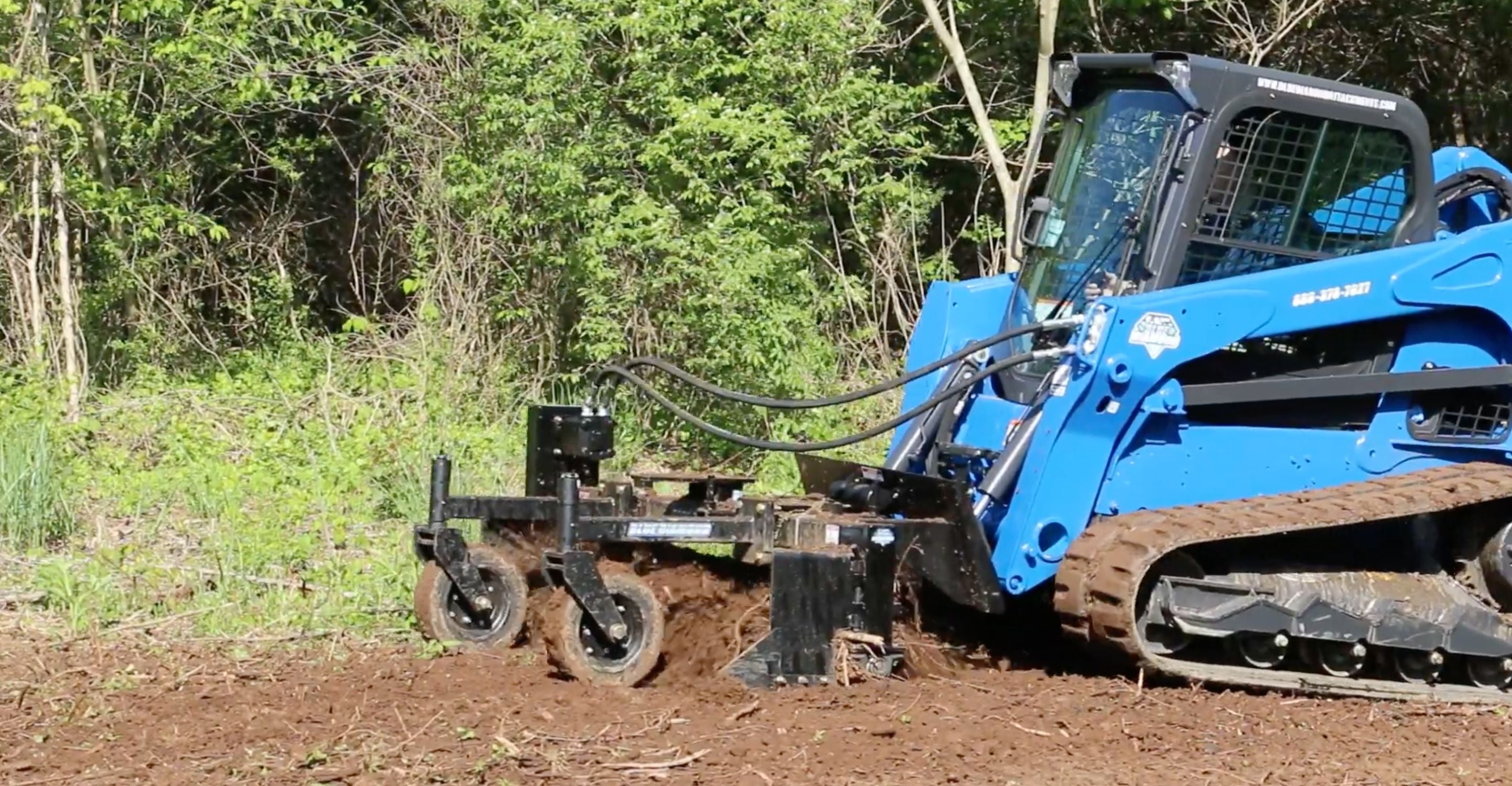 Skid steer conditioning the soil using the power rake attachment of Blue Diamond