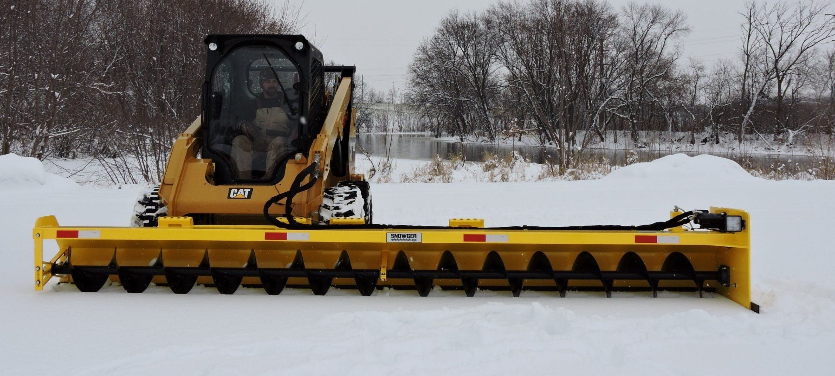 Caterpillar skid steer with the snowgrr attachment