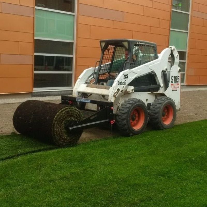 Bobcat skid steer rolling grass using the Blue Diamond sod roller attachment