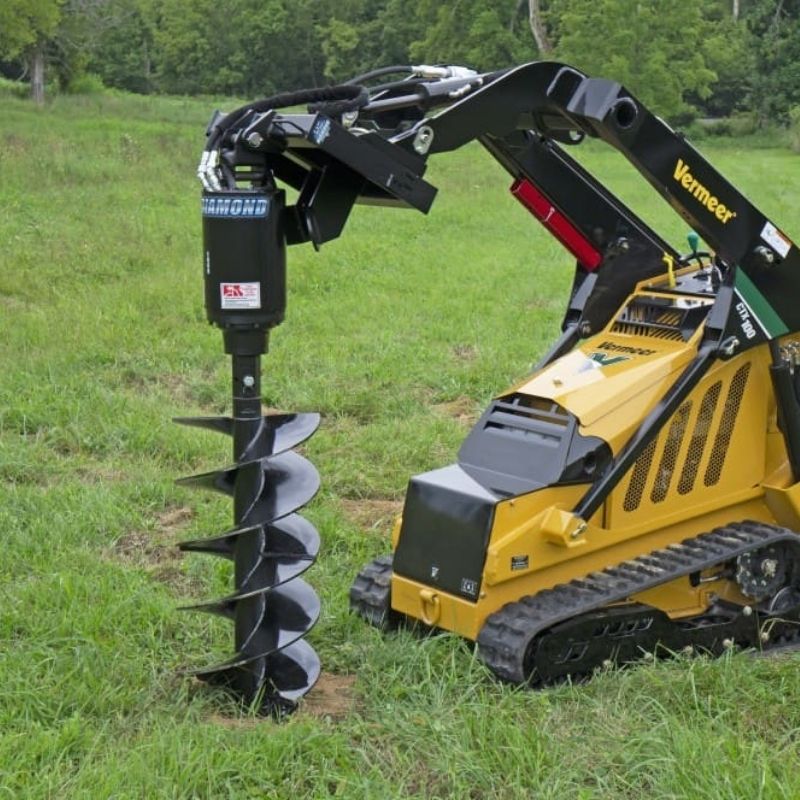 Vermeer mini skid steer drilling the hole using the Blue Diamond auger attachment