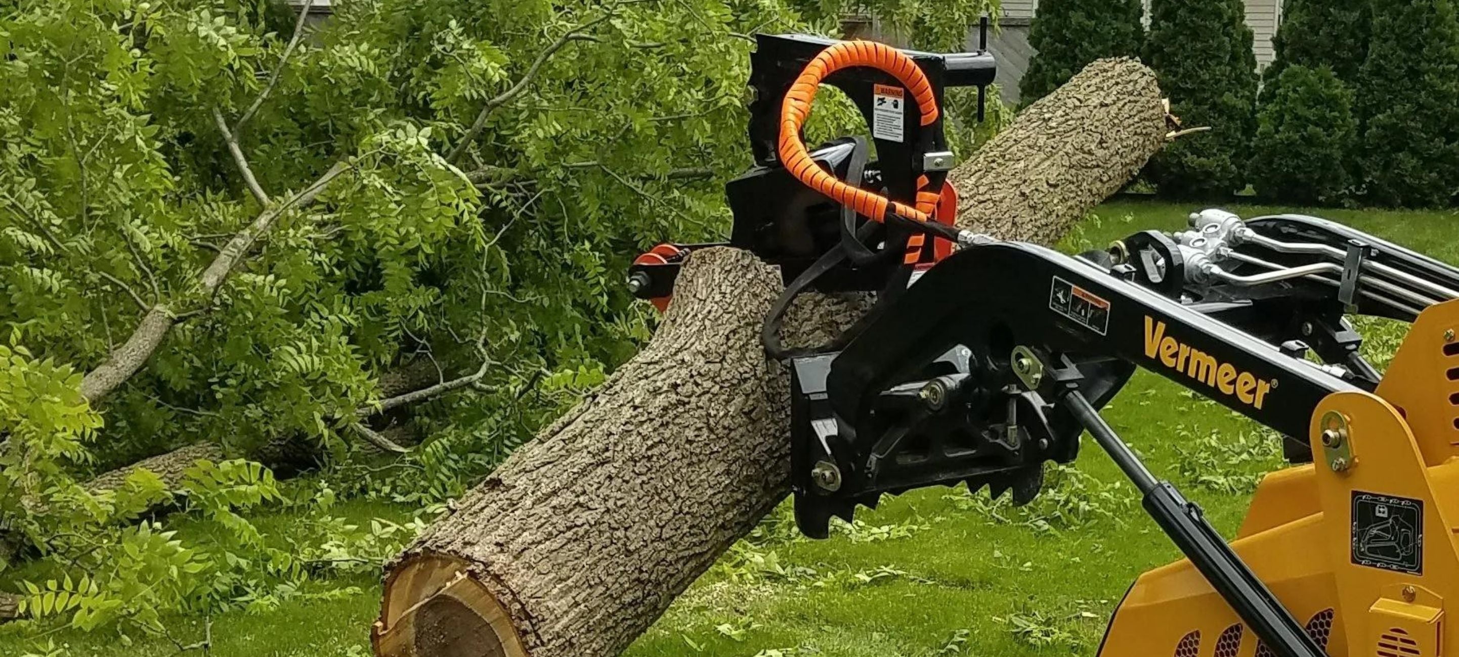 Holding the big log in the forest using the Vermeer with the log grapple attachment 