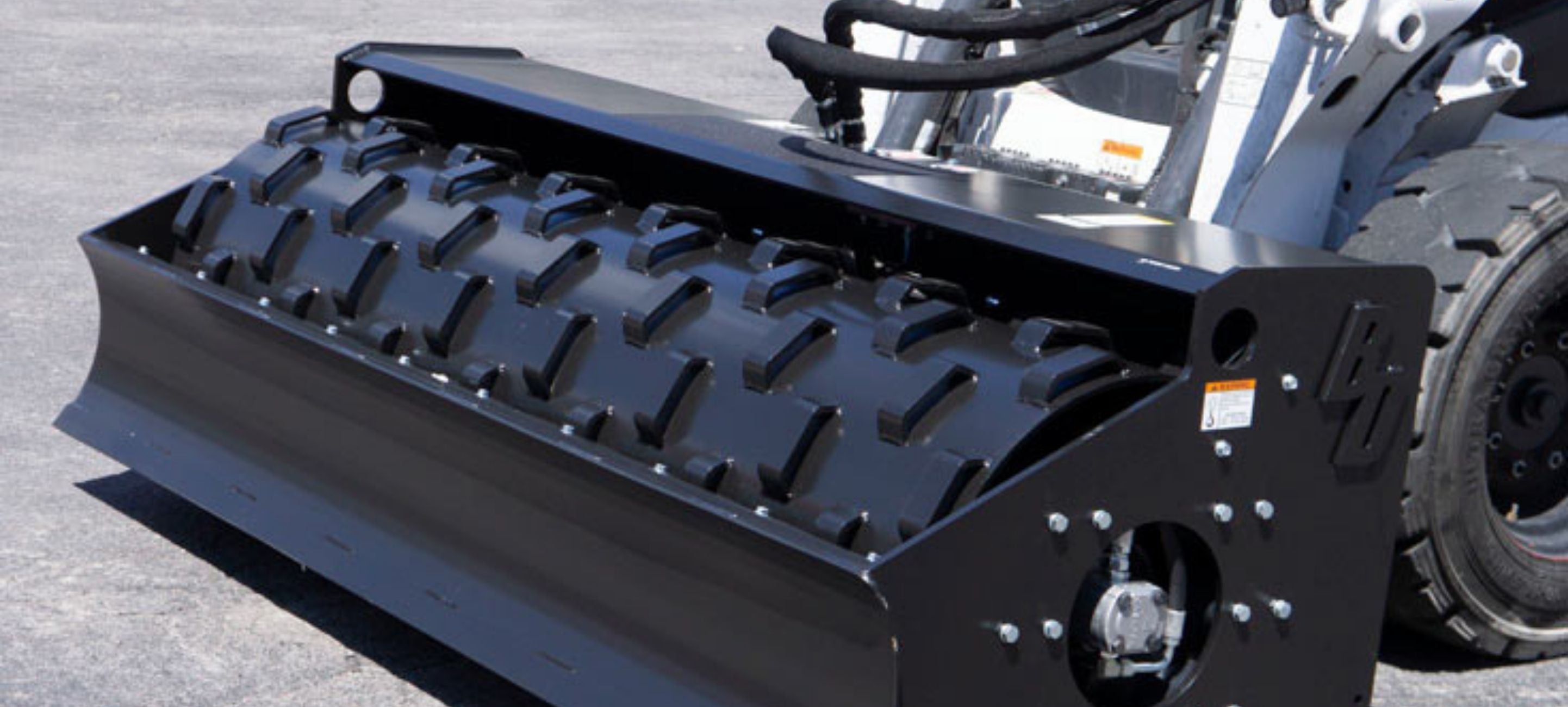 Skid steer with the vibratory roller attachment