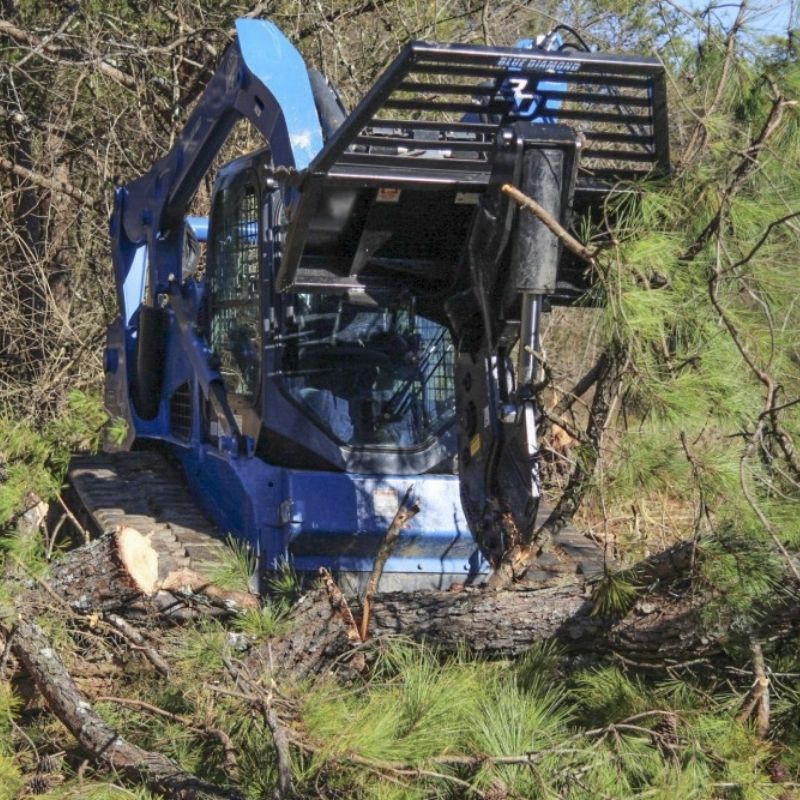 Shearing trees in the forest with the Blue Diamond tree shear attachment