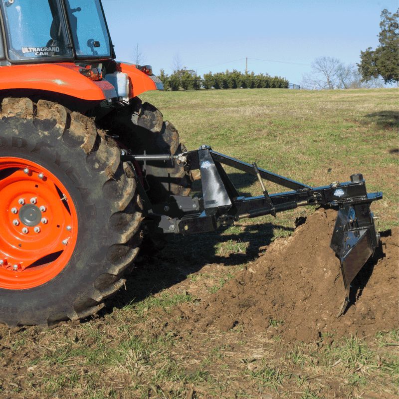 tractor with the blue diamond grader blade 3 point attachment