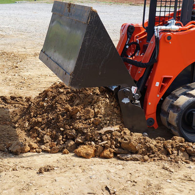 4 in 1 bucket being used as dozer blade to move earth