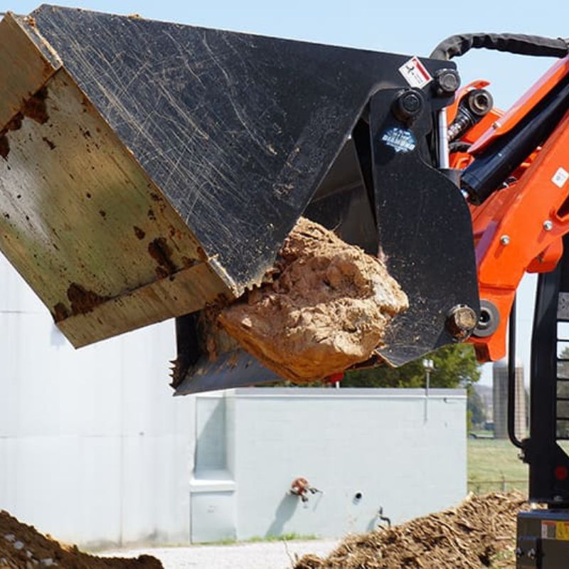 4 in 1 bucket being used as a grapple to move debris