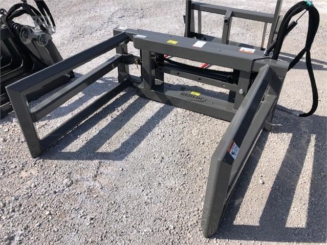 Skid steer bale handler on the ground