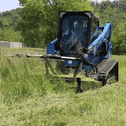 skid steer cutting grass with a blue diamond brush cutter