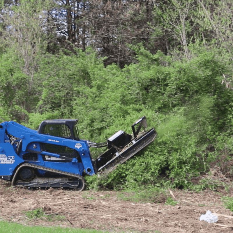 skid steer in action with the blue diamond severe duty brush cutter