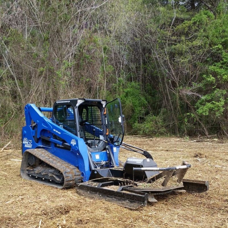 skid steer with a blue diamond brush cutter severe duty