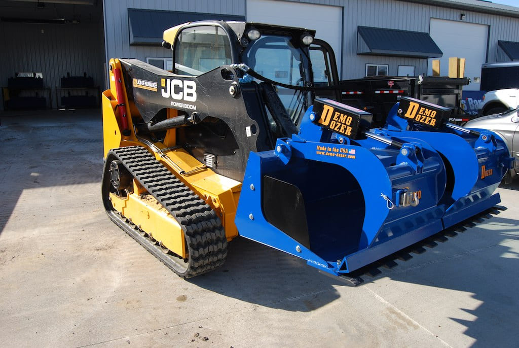 JCB skid steer with the grapple bucket attachment from demo dozer
