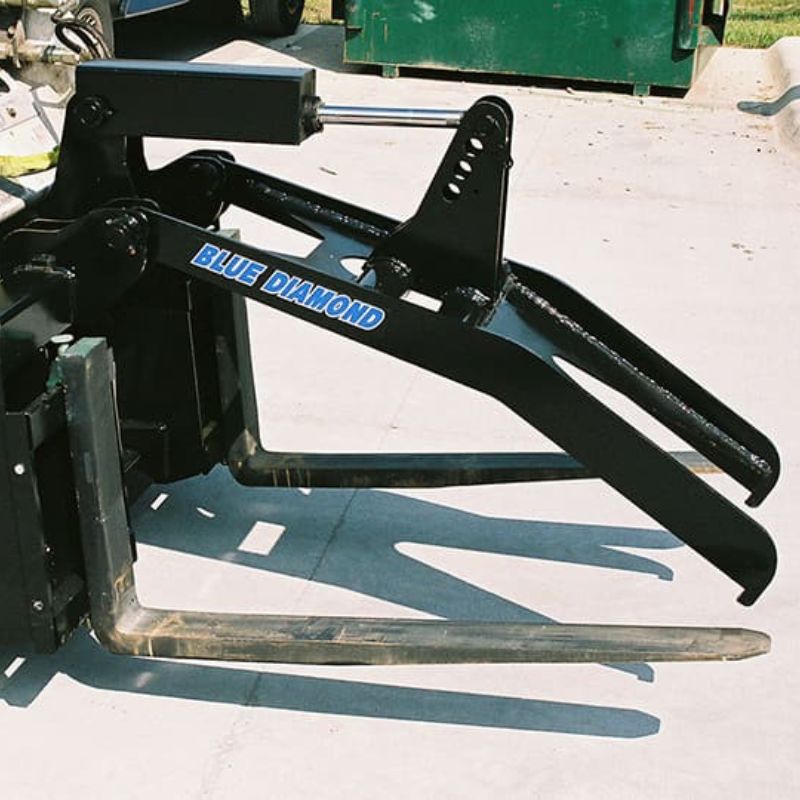skid steer with grapple fork attachment ready to action