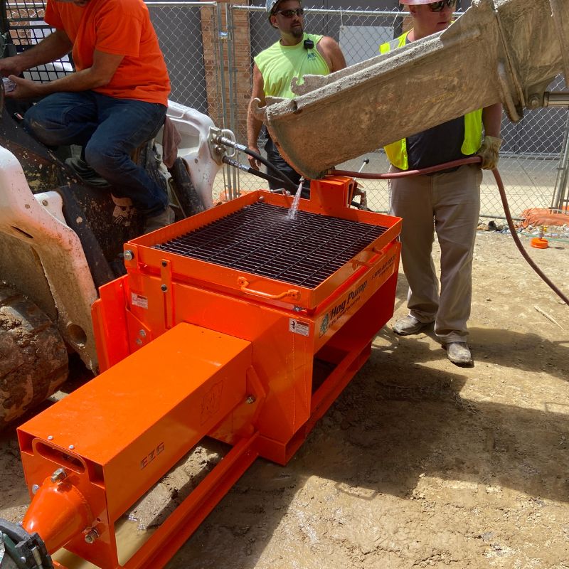 Men using the Hog Pump of EZG Manufacturing. 