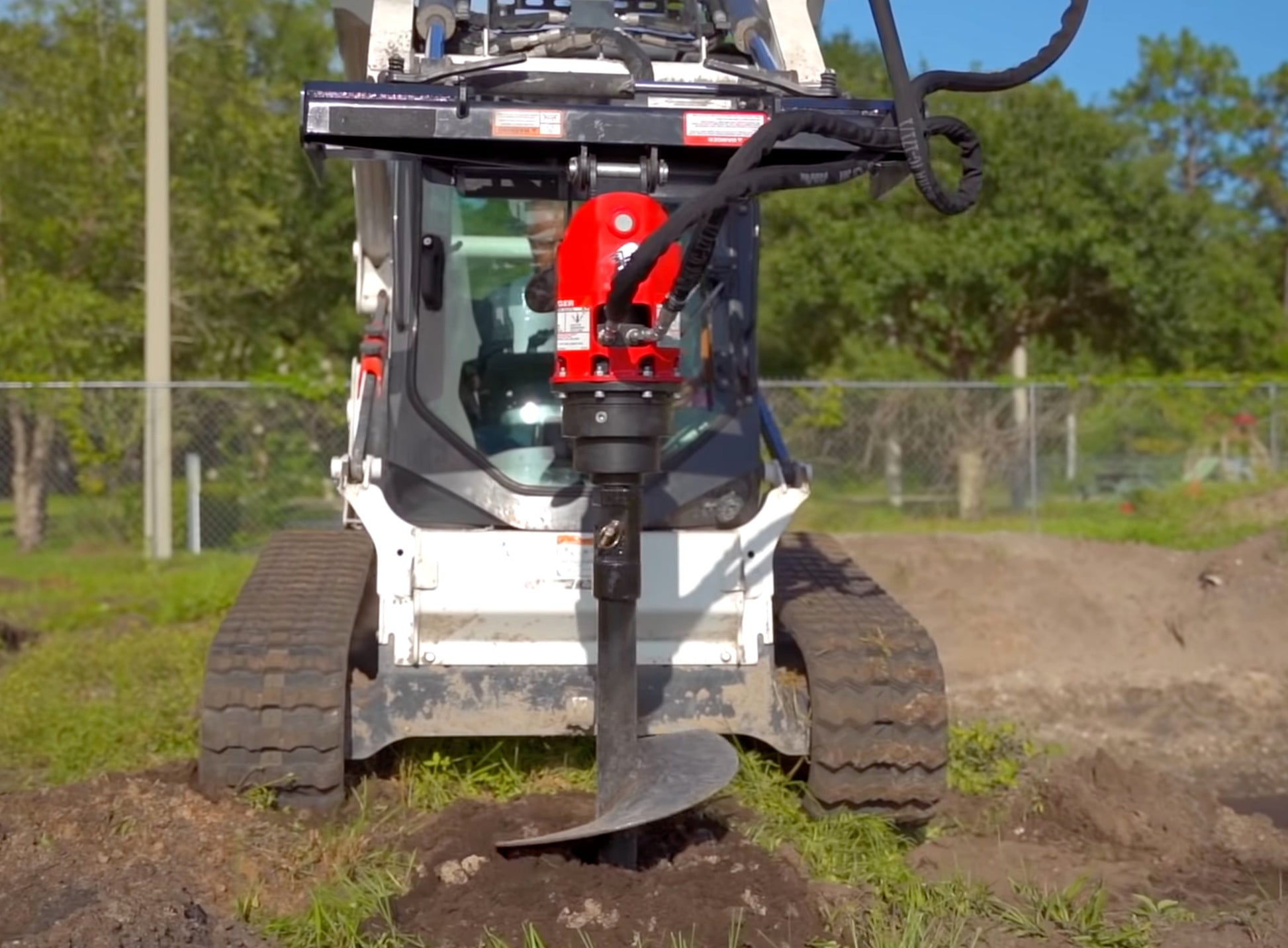 drilling hole with the auger attachment for skid steer by mclaren