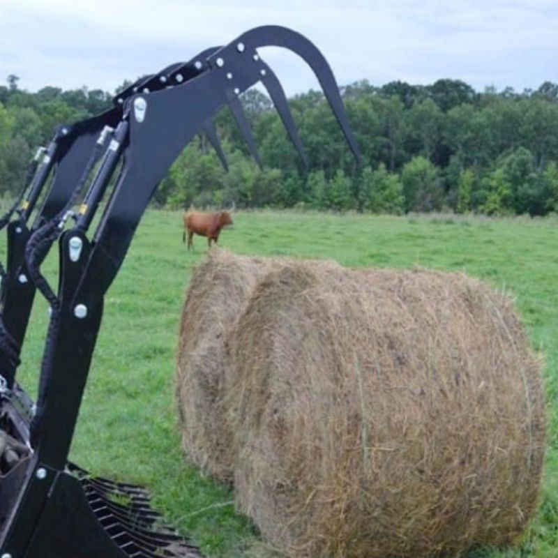 bale grapple attachment from top dog in action on the field