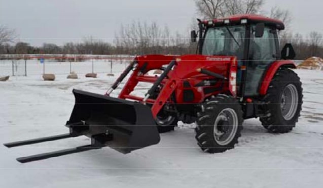 tractor with the Clamp-On Pallet Forks attachment in action