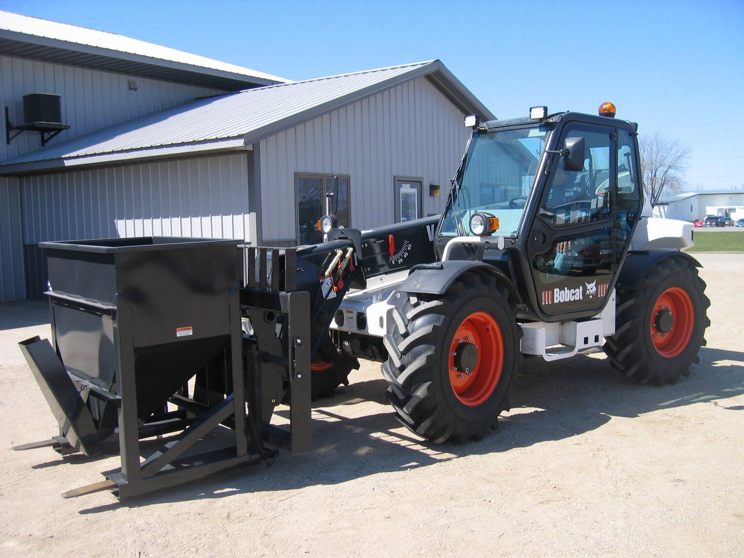 forklift concrete hopper on telehandler before loading