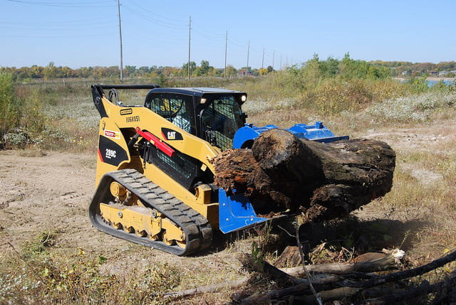 cat skid steer with the demo dozer grapple bucket attachment