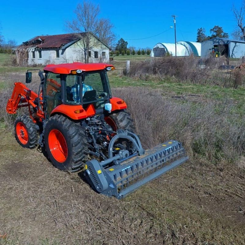 tractor with blue diamond flail mower attachment in action