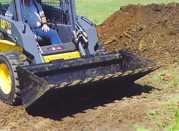 skid steer in action with the heavy duty cotton seed and ultra lite bucket from star industries