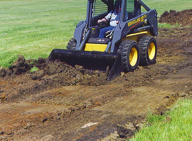 new holland skid steer in action with the star industries utility bucket attachment