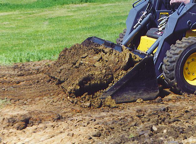 skid steer up close in action with the low profile dirt bucket from star industries