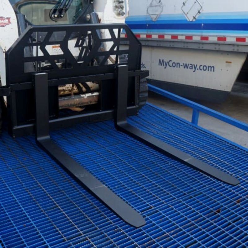 skid steer with the heavy duty blue diamond pallet forks