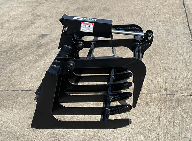 mini skid steer root grapple bucket from star industries on the ground
