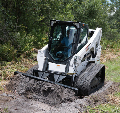 land clearing with the 4 way dozer blade attachment on a bobcat skid steer by mclaren