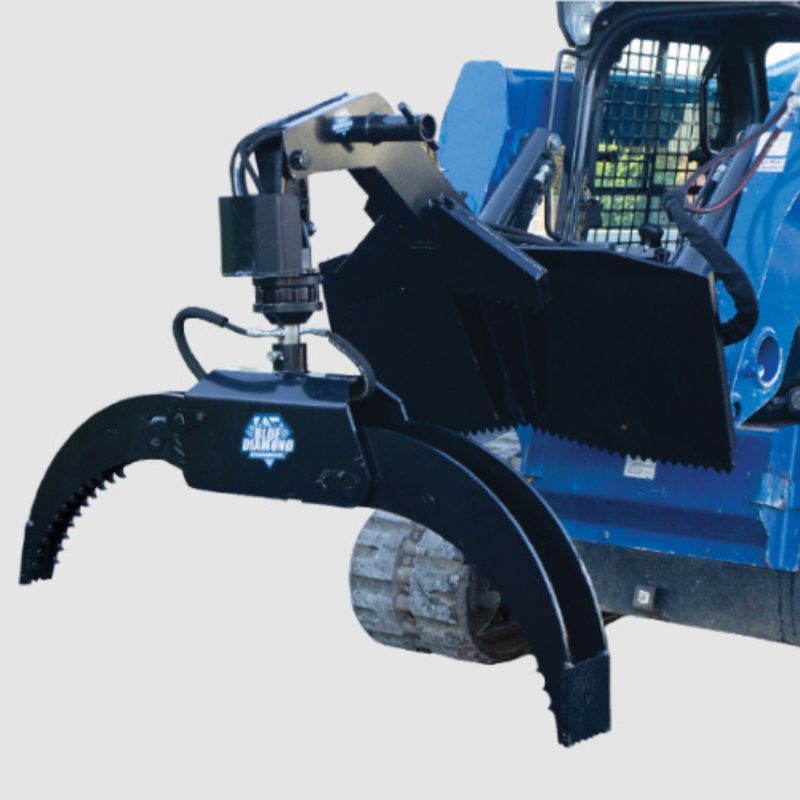 skid steer with the blue diamond log grapple ready to action