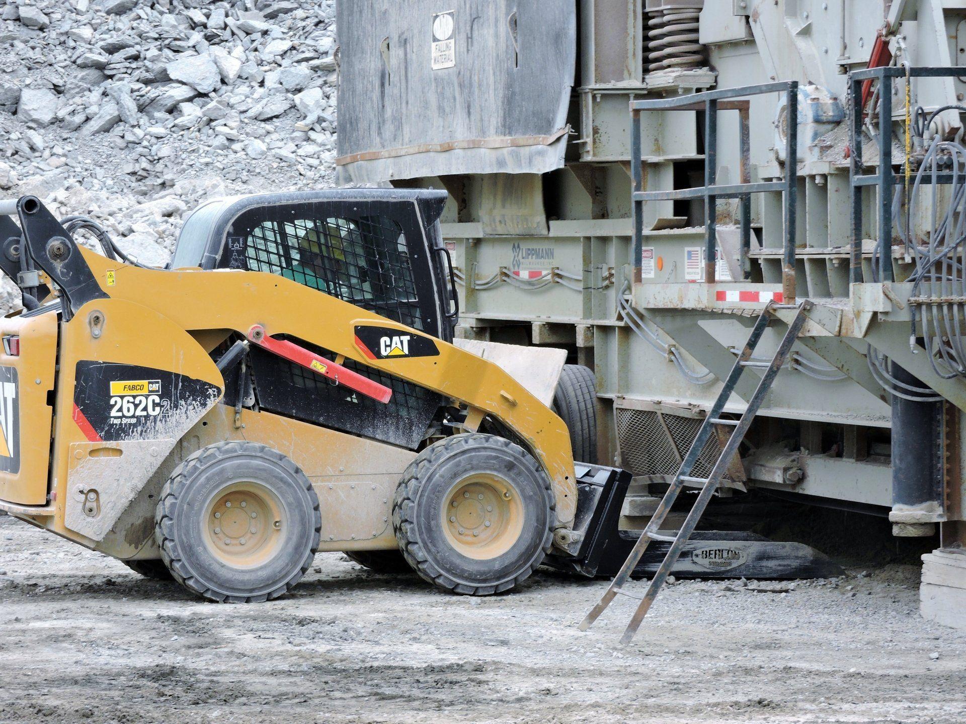 Material Long Bucket Berlon Industries in action with the Cat Skid Steer in the field