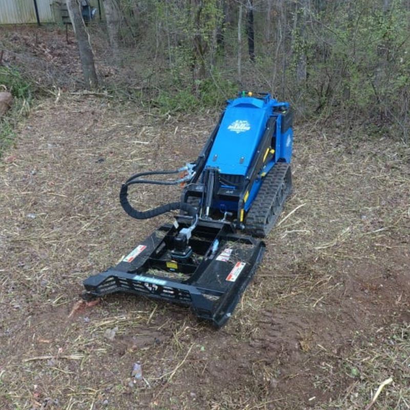  mini skid steer with the blue diamond brush cutter in action