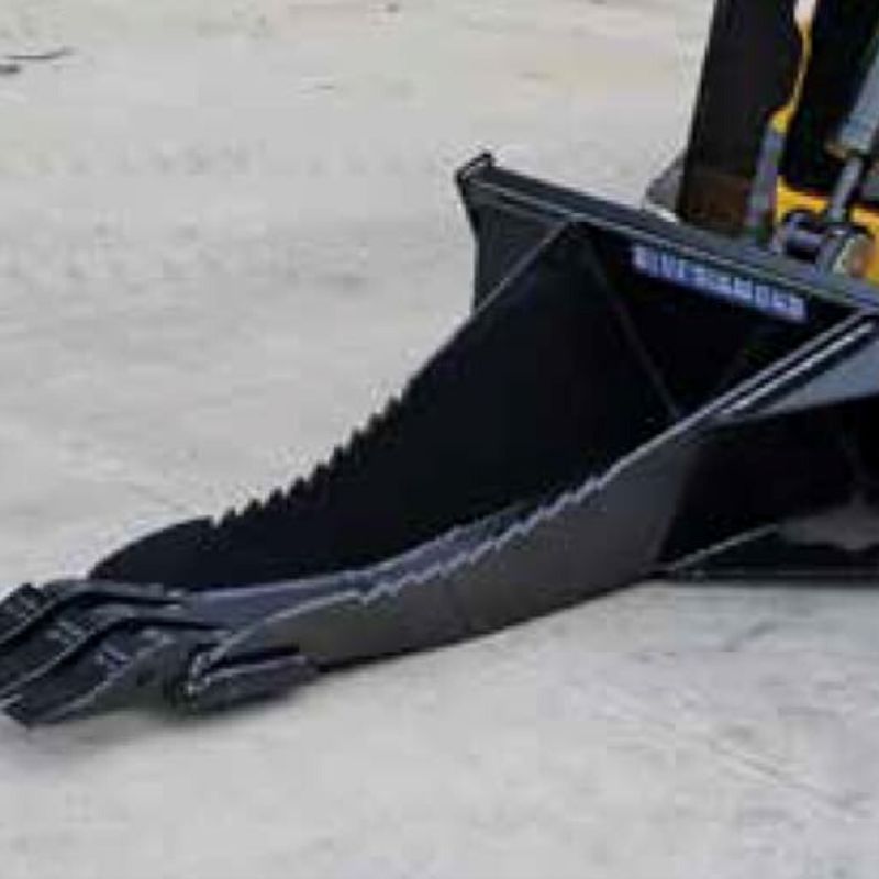 mini skid steer with blue diamond stump bucket on the ground