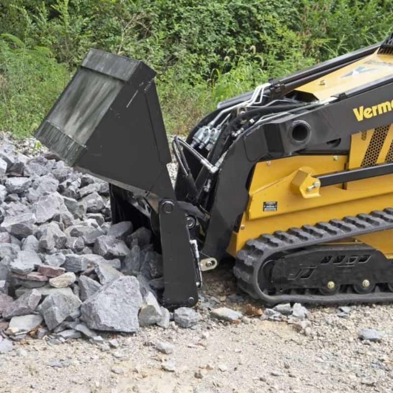 mini skid steer in action with the blue diamond 4 in 1 bucket attachment