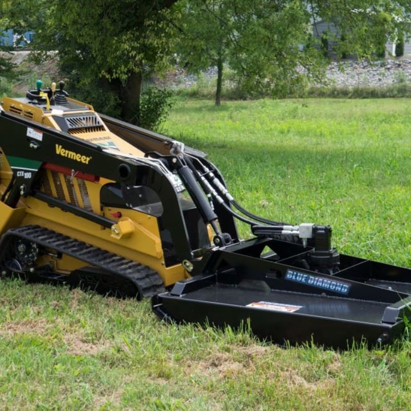 vermeer mini skid steer in the field with the blue diamond mini brush cutter