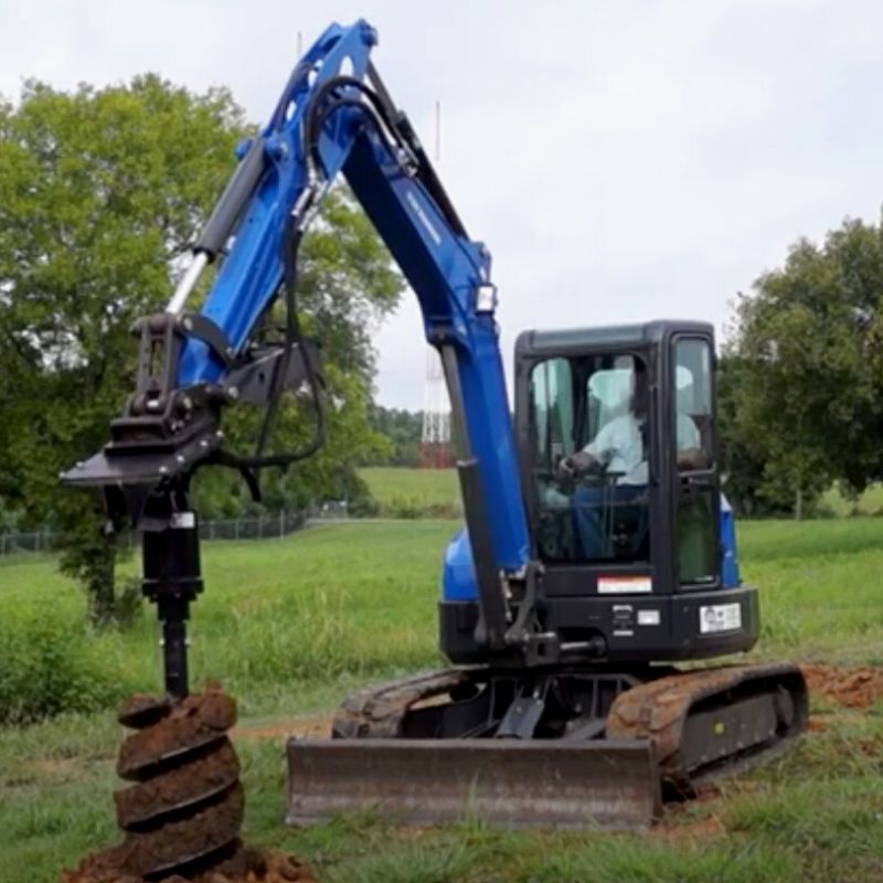 mini excavator with blue diamond auger attachement in action