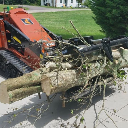 mini skid steer in action with the blue diamond attachment