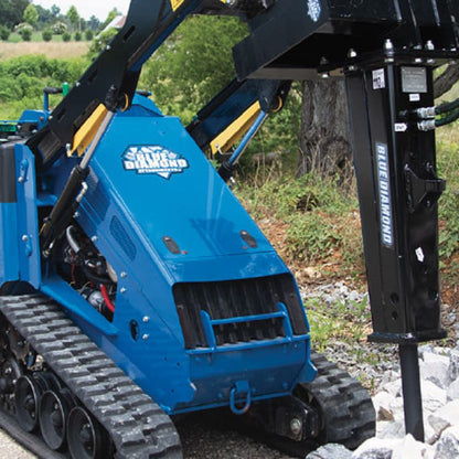 mini skid steer with the hydraulic breaker attachment in action