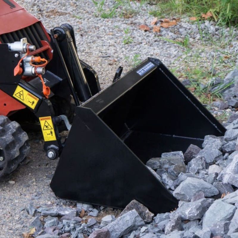 mini skid steer with the blue diamond bucket attachment in action