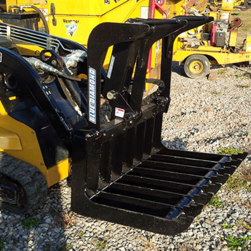 vermeer mini skid steer in the field with the blue diamond mini root grapple attachment