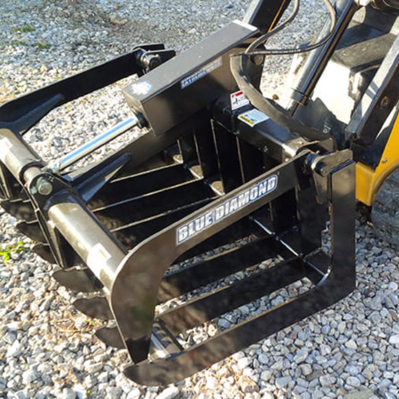 blue diamond mini root grapple attached on a mini skid steer