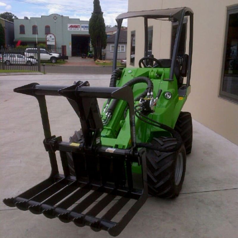 ready to action mini skid steer with blue diamond mini root grapple