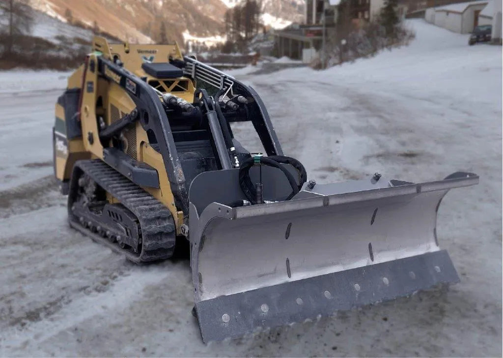mini snow blade on a mini skid steer ready to action