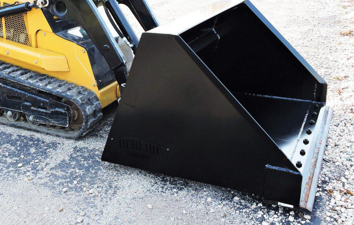 up close on the ground is the snow and light material bucket attachment from berlon for mini skid steer