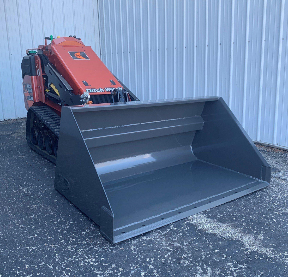 ditch witch mini skid steer with the snow and light material bucket attachment from berlon