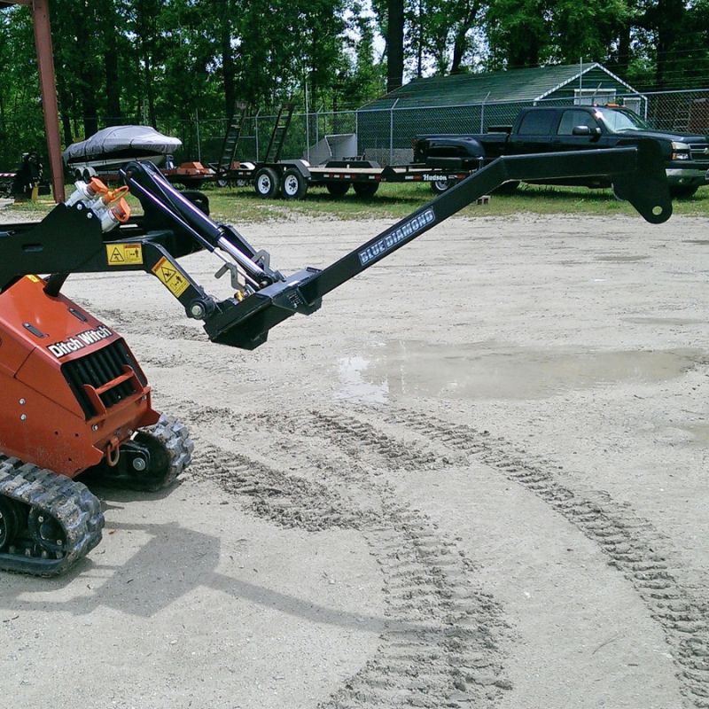 ditch witch mini skid steer with the blue diamond mini tree boom attachment