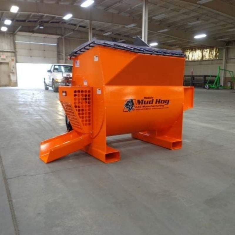 Skid Steer concrete mixer from ezg manufacturing on the ground