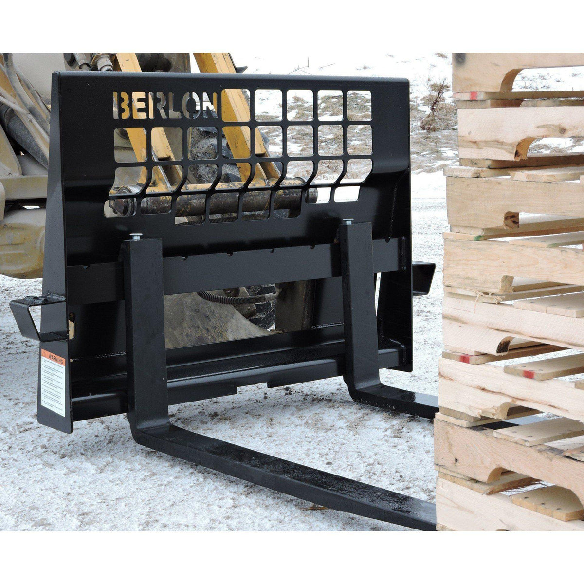 skid steer with the berlon industries heavy duty pallet forks attachment